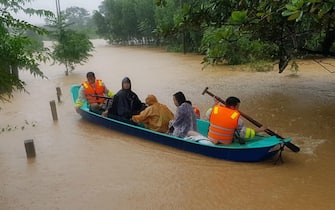 epa08754552 Municipal workers evacuate local people from flood waters in Quang Tri province, Vietnam, 18 October 2020. Heavy rains and floods killed at least 62 people in northern and central Vietnam over the past few days, according to media reports.  EPA/STR VIETNAM OUT  EDITORIAL USE ONLY/NO SALES