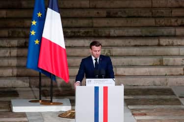 French President Emmanuel Macron delivers a speech in front of Samuel Paty's coffin inside Sorbonne University's courtyard in Paris on October 21, 2020, during a national homage to French teacher Samuel Paty, who was beheaded for showing cartoons of the Prophet Mohamed in his civics class. - France pays tribute on October 21 to a history teacher beheaded for showing cartoons of the Prophet Mohamed in a lesson on free speech, an attack that has shocked the country and prompted a government crackdown on radical Islam. Seven people, including two schoolchildren, will appear before an anti-terror judge for a decision on criminal charges over the killing of 47-year-old history teacher Samuel Paty. (Photo by Francois Mori / POOL / AFP) (Photo by FRANCOIS MORI/POOL/AFP via Getty Images)