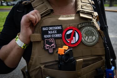 An attendee wears a "Three Percenter" patch during a Proud Boys rally at Delta Park in Portland, Oregon on September 26, 2020. - Far-right group "Proud Boys" members gather in Portland to show support to US president Donald Trump and to condemn violence that have been occurring for more than three months during "Black Lives Matter" and "Antifa" protests. (Photo by Maranie R. STAAB / AFP) (Photo by MARANIE R. STAAB/AFP via Getty Images)