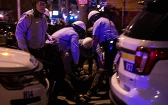 Police arrest a protester during a demonstration in West Philadelphia on October 27, 2020, against the fatal shooting of 27-year-old Walter Wallace, a Black man, by police. - Hundreds of people demonstrated in Philadelphia late on October 27, with looting and violence breaking out in a second night of unrest after the latest police shooting of a Black man in the US. The fresh unrest came a day after the death of 27-year-old Walter Wallace, whose family said he suffered mental health issues. On Monday night hundreds of demonstrators took to the streets, with riot police pushing them back with shields and batons. (Photo by GABRIELLA AUDI / AFP) (Photo by GABRIELLA AUDI/AFP via Getty Images)