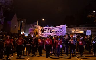 Protesters march through West Philadelphia on October 27, 2020, during a demonstration against the fatal shooting of 27-year-old Walter Wallace, a Black man, by police. - Hundreds of people demonstrated in Philadelphia late on October 27, with looting and violence breaking out in a second night of unrest after the latest police shooting of a Black man in the US. The fresh unrest came a day after the death of 27-year-old Walter Wallace, whose family said he suffered mental health issues. On Monday night hundreds of demonstrators took to the streets, with riot police pushing them back with shields and batons. (Photo by GABRIELLA AUDI / AFP) (Photo by GABRIELLA AUDI/AFP via Getty Images)