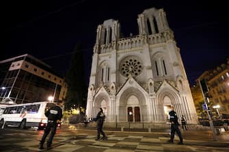 epa08783993 French police officers secure the street near the entrance of the Notre Dame Basilica church in Nice, France, 29 October 2020, following a knife attack. Three people have died in what officials treat as a terror attack. The attack comes less than a month after the beheading of a French middle school teacher in Paris on 16 October.  EPA/SEBASTIEN NOGIER