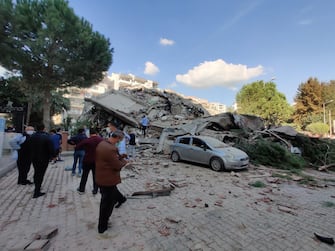 epa08785700 People near a collapsed building after a 7.0 magnitude earthquake in the Aegean Sea in Izmir, Turkey, 30 October 2020. According to Turkish media reports dozens of buildings were destroyed in the earthquake.

TURKEY OUT, USA OUT, UK OUT, CANADA OUT, FRANCE OUT, SWEDEN OUT, IRAQ OUT, JORDAN OUT, KUWAIT OUT, LEBANON OUT, OMAN OUT, QATAR OUT, SAUDI ARABIA OUT, SYRIA OUT, UAE OUT, YEMEN OUT, BAHRAIN OUT, EGYPT OUT, LIBYA OUT, ALGERIA OUT, MOROCCO OUT, TUNISIA OUT, AZERBAIJAN OUT, ALBANIA OUT, BOSNIA HERZEGOVINA OUT, BULGARIA OUT, KOSOVO OUT, CROATIA OUT, MACEDONIA OUT, MONTENEGRO OUT, SERBIA OUT, TURKEY OUT, USA OUT, UK OUT, CANADA OUT, FRANCE OUT, SWEDEN OUT, IRAQ OUT, JORDAN OUT, KUWAIT OUT, LEBANON OUT, OMAN OUT, QATAR OUT, SAUDI ARABIA OUT, SYRIA OUT, UAE OUT, YEMEN OUT, BAHRAIN OUT, EGYPT OUT, LIBYA OUT, ALGERIA OUT, MOROCCO OUT, TUNISIA OUT, AZERBAIJAN OUT, ALBANIA OUT, BOSNIA HERZEGOVINA OUT, BULGARIA OUT, KOSOVO OUT, CROATIA OUT, MACEDONIA OUT, MONTENEGRO OUT, SERBIA OUT,  EPA/Mehmet Emin Menguarslan  SHUTTERSTOCK OUT *** Local Caption *** 54838622