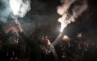 Two protesters hold lit flares during the demonstration in front of the Barcelona Cathedral.
Under the slogan Barcelona War Zone, anti-eviction collectives of Barcelona have demonstrated to denounce the wave of evictions suffered by families in Barcelona. After the end of the demonstration there have been some riots and police charges. (Photo by Paco Freire / SOPA Images/Sipa USA)