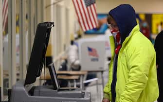 A voter casts his ballot at a polling station on US Election Day in Winchester, Virginia early November 3, 2020. - Polling stations opened in New York, New Jersey and Virginia early November 3, marking the start of US Election Day as President Donald Trump seeks to beat forecasts and defeat challenger Joe Biden. The vote is widely seen as a referendum on Trump and his uniquely brash, bruising presidency that Biden urged Americans to end to restore "our democracy." (Photo by ANDREW CABALLERO-REYNOLDS / AFP) (Photo by ANDREW CABALLERO-REYNOLDS/AFP via Getty Images)