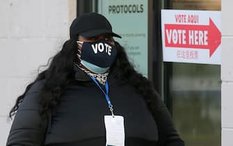 WASHINGTON, D.C., USA - NOVEMBER 3, 2020: A voter wears a face mask outside a polling station on Election Day as she waits in line to vote in the 2020 general elections.The USA elect a president and vice president, 35 Senators, all 435 members of the House of Representatives, 13 governors of 11 states and two US territories, as well as state and local government officials. Incumbent Republican President Donald Trump and Democratic Party nominee Joe Biden are running for president. Yegor Aleyev/TASS/Sipa USA