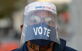 WASHINGTON, D.C., USA - NOVEMBER 3, 2020: A voter wears a face mask and a face shield outside a polling station on Election Day during the 2020 general elections. The USA elect a president and vice president, 35 Senators, all 435 members of the House of Representatives, 13 governors of 11 states and two US territories, as well as state and local government officials. Incumbent Republican President Donald Trump and Democratic Party nominee Joe Biden are running for president. Yegor Aleyev/TASS/Sipa USA