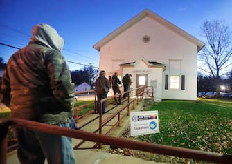 epa08795045 Voters wait in line before dawn and before the doors open at a polling location at the Edinburg Town Hall in Edinburg, Ohio, USA, 03 November 2020. Americans vote on Election Day to choose between re-electing Donald J. Trump or electing Joe Biden as the 46th President of the United States to serve from 2021 through 2024.  EPA/DAVID MAXWELL