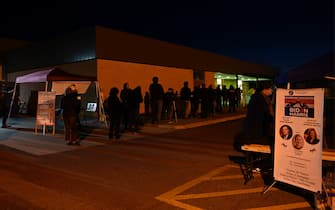 Voters wait in line at a polling station on US Election Day in Winchester, Virginia early November 3, 2020. - Polling stations opened in New York, New Jersey and Virginia early November 3, marking the start of US Election Day as President Donald Trump seeks to beat forecasts and defeat challenger Joe Biden. The vote is widely seen as a referendum on Trump and his uniquely brash, bruising presidency that Biden urged Americans to end to restore "our democracy." (Photo by ANDREW CABALLERO-REYNOLDS / AFP) (Photo by ANDREW CABALLERO-REYNOLDS/AFP via Getty Images)