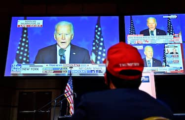 epa08797623 A President Donald Trump supporter listens to Democratic Presidential candidate Joe Biden during a Republican watch party at the South Point Hotel & Casino in Las Vegas, Nevada, USA, 03 November 2020. Americans vote on Election Day to choose between re-electing Donald J. Trump or electing Joe Biden as the 46th President of the United States to serve from 2021 through 2024.  EPA/DAVID BECKER