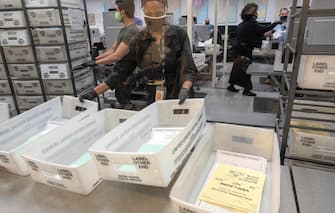 epaselect USA ELECTION DAY 2020 epaselect epa08796968 Election workers count ballots during Election Day at the Miami-Dade Elections Department in Miami, Florida, USA, 03 November 2020. Americans vote on Election Day to choose between re-electing Donald J. Trump or electing Joe Biden as the 46th President of the United States to serve from 2021 through 2024. EPA/CRISTOBAL HERRERA-ULASHKEVICH