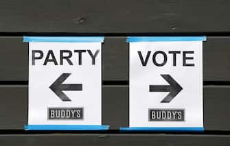 epaselect epa08796945 Signs are seen where to  party  and  vote  from at a polling location in Houston, Texas, USA, 03 November 2020. Buddy s became the world s first presidential polling location at an LGBTQ+ bar. Americans vote on Election Day to choose between re-electing Donald J. Trump or electing Joe Biden as the 46th President of the United States to serve from 2021 through 2024.  EPA/AARON M. SPRECHER