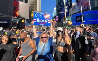 People celebrate at Times Square in New York after Joe Biden was declared winner of the 2020 presidential election on November 7, 2020 (Photo by Kena Betancur / AFP) (Photo by KENA BETANCUR/Afp/AFP via Getty Images)