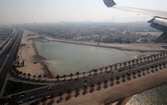 A picture taken on October 18, 2020, through the window of a plane carrying a US-Israeli delegation, shows a view of a highway in Manama ahead of landing at the Bahrain International airport. - Israel and Bahrain will officially establish diplomatic relations at a ceremony in Manama, an Israeli official said, after the two states reached a US-brokered normalisation deal last month. (Photo by RONEN ZVULUN / POOL / AFP) (Photo by RONEN ZVULUN/POOL/AFP via Getty Images)
