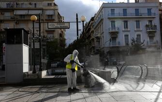 GREECE PANDEMIC CORONAVIRUS COVID19 epa08807130 A municipal worker disinfects the Victoria square in Athens, Greece, 08 November 2020. New restrictions have been enforced in Athens amid a second wave of COVID-19 infections sweeping through Europe. EPA/ORESTIS PANAGIOTOU