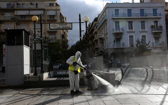 epa08807130 A municipal worker disinfects the Victoria square in Athens, Greece, 08 November 2020. New restrictions have been enforced in Athens amid a second wave of COVID-19 infections sweeping through Europe.  EPA/ORESTIS PANAGIOTOU