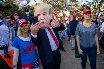 epa08820669 Supporters of US President Donald J. Trump march to the Supreme Court in Washington, DC, USA, 14 November 2020. US President Donald J. Trump has refused to concede the 2020 Presidential election to his Democratic challenger President Elect Joe Biden.  EPA/SHAWN THEW