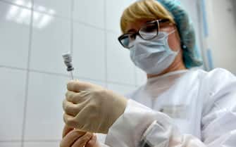 A nurse prepares to inoculate volunteer Ilya Dubrovin, 36, with Russia's new coronavirus vaccine in a post-registration trials at a clinic in Moscow on September 10, 2020. - Russia announced last month that its vaccine, named "Sputnik V" after the Soviet-era satellite that was the first launched into space in 1957, had already received approval. The vaccine was developed by the Gamaleya research institute in Moscow in coordination with the Russian defence ministry. (Photo by Natalia KOLESNIKOVA / AFP) (Photo by NATALIA KOLESNIKOVA/AFP via Getty Images)