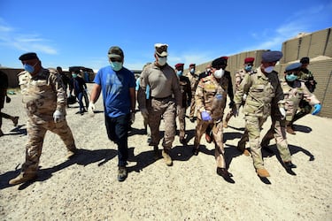 epa08343382 US Marine Corps Col. Scott Mayfield (3-L) walks with Iraq's Staff Major General Mohammad Fadhel Abbas (3-R) and other Iraqi army officers during the handover ceremony of the Al-Taqaddum Airbase (Habbaniyah), western Baghdad, Iraq on 04 April 2020. The US-led Coalition announced their official withdrawal from the Al-Taqaddum Airbase (Habbaniyah) in Iraq's Anbar Governorate, and transferring equipment and buildings worth approximately 3.5 million US dollars to the Iraqi government. The airbase is located in Habbaniyah, approximately 74 kilometers west of Baghdad.  EPA/MURTAJA LATEEF
