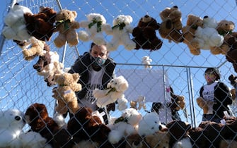 WASHINGTON, DC - NOVEMBER 16: Lisa Watkins, a volunteer with pro-immigration group Families Belong Together, works to fill a chainlink cage with about 600 teddy bears 'representing the children still separated as a result of U.S. immigration policies' on the National Mall November 16, 2020 in Washington, DC. Organized by the National Domestic Workers Alliance, Families Belong Together was formed in 2018 in response to the Trump Administration's policy of separating children from their parents after they enter the U.S. to seek refuge, resulting in hundreds of children unable to be reunited with their families because of poor administration and tracking. (Photo by Chip Somodevilla/Getty Images)