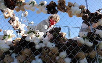 WASHINGTON, DC - NOVEMBER 16: Director of the Refugee & Immigration Ministries for the Christian Church (Disciples of Christ) Rev. Dr. Sharon Stanley-Rea works with pro-immigration group Families Belong Together to build and fill a chainlink cage with about 600 teddy bears 'representing the children still separated as a result of U.S. immigration policies' on the National Mall November 16, 2020 in Washington, DC. Organized by the National Domestic Workers Alliance, Families Belong Together was formed in 2018 in response to the Trump Administration's policy of separating children from their parents after they enter the U.S. to seek refuge, resulting in hundreds of children unable to be reunited with their families because of poor administration and tracking. (Photo by Chip Somodevilla/Getty Images)