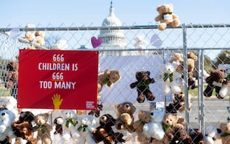 TOPSHOT - Volunteers and staff with Families Belong Together and the Franciscan Action Network (FAN), install more than 600 teddy bears in a chain-link cage to represent children separated from their families by US immigration policies, during a protest exhibit near the US Capitol in Washington, DC, November 16, 2020. (Photo by SAUL LOEB / AFP) (Photo by SAUL LOEB/AFP via Getty Images)