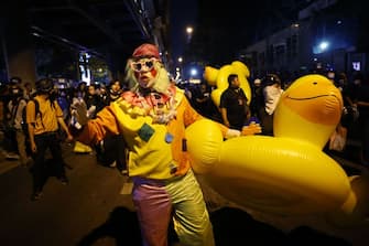 A clown carries a large inflatable duck as pro-democracy protesters take part in an anti-government rally in Bangkok on November 18, 2020. (Photo by Jack TAYLOR / AFP) (Photo by JACK TAYLOR/AFP via Getty Images)