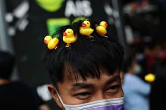 A protester wears small yellow ducks on their head during a 'Bad Student' rally in Bangkok on November 21, 2020. (Photo by Jack TAYLOR / AFP) (Photo by JACK TAYLOR/AFP via Getty Images)
