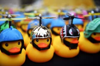 TOPSHOT - Figures of small yellow rubber ducks, which have become a recent symbol for the ongoing pro-democracy protests, are displayed for sale at an anti-government rally in Bangkok on November 22, 2020. (Photo by Lillian SUWANRUMPHA / AFP) (Photo by LILLIAN SUWANRUMPHA/AFP via Getty Images)