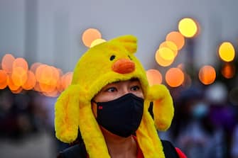 TOPSHOT - A pro-democracy protester wears a hat in the shape of a yellow rubber duck, which has become a recent symbol for the ongoing protests, during an anti-government rally in Bangkok on November 22, 2020. (Photo by Lillian SUWANRUMPHA / AFP) (Photo by LILLIAN SUWANRUMPHA/AFP via Getty Images)