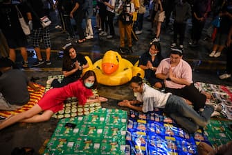 BANGKOK, THAILAND - NOVEMBER 21: Protesters pose for a photo in front of an inflatable yellow rubber duck in the Siam area on November 21, 2020 in Bangkok, Thailand. Pro-democracy protesters kept up the pressure on the Thai government with a protest organised by students on Saturday after tensions flared between demonstrators and police earlier in the week. (Photo by Sirachai Arunrugstichai/Getty Images)