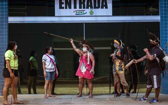 epa08463360 A group of indigenous people from the Satere-Mawe protest in front of a room of the Nilton Lins Hospital, built to treat the cases of the Covid-19 of indigenous peoples, in Manaus, Brazil, 03 June 2020. The Satere-Mawe people protest that they do not receive special attention from the State Government, since the indigenous people have to go through other health units before being transferred.  EPA/RAPHAEL ALVES