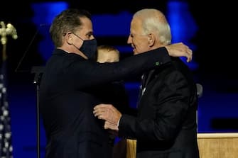 epa08806665 President-elect Joe Biden (R) embraces his son Hunter Biden (L) during a celebratory event held outside of the Chase Center in Wilmington, Delaware, USA, 07 November 2020. According to media reports, Biden has defeated President Donald Trump in the 2020 USA presidential election to become the United Sates' 46th president.  EPA / ANDREW HARNIK / POOL