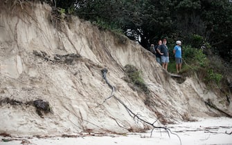 1230116669 BYRON BAY, AUSTRALIA - DECEMBER 14: Local residents check the damage along the stretch of beaches due to erosion, December 14, 2020 in Byron Bay, Australia. Byron Bay's beaches face further erosion as wild weather and hazardous swells lash the northern NSW coastlines. (Photo by Regi Varghese/Getty Images)