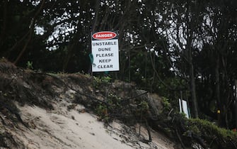 BYRON BAY, AUSTRALIA - DECEMBER 14:  Warning sign along coastal area facing erosion, December 14, 2020 in Byron Bay, Australia. Byron Bay's beaches face further erosion as wild weather and hazardous swells lash the northern NSW coastlines. (Photo by Regi Varghese/Getty Images)                                    