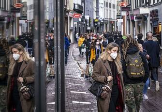 People wearing face masks walk on a shopping street in the center of Amsterdam on October 11, 2020. - The Dutch government is expected to take new measures to halt the spread the Covid-19 disease caused by the novel coronavirus. (Photo by Ramon van Flymen / ANP / AFP) / Netherlands OUT (Photo by RAMON VAN FLYMEN/ANP/AFP via Getty Images)