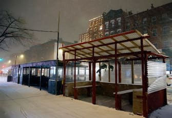 epa08889115 An empty outside dining areas in the East Village of New York, USA, 16 December 2020. New York City restaurants have been ordered to close outdoor dining areas as forecasts expect up to 35 centimeters of snow.  EPA/JASON SZENES