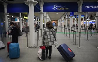 LONDON, ENGLAND - DECEMBER 20: A woman is seen queuing for the Eurostar at St Pancras train station on December 20, 2020 in London, England. London and large parts of southern England were moved into a newly created "Tier 4" lockdown, closing non-essential shops and limiting household mixing. The government also scrapped a plan to allow multi-household "bubbles" to form for over a 5-day period around Christmas. (Photo by Peter Summers/Getty Images)