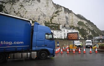 epa08897848 A freight lorry passes as the Port of Dover remains closed in Dover, Britain, 21 December 2020. France has closed its border with the UK for 48 hours over concerns about the new coronavirus variant. Freight lorries cannot cross by sea or through the Eurotunnel and the Port of Dover has closed to outbound traffic.  EPA/NEIL HALL