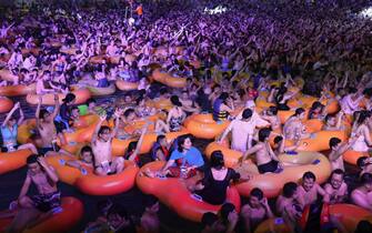 epa08615865 People enjoy a music party inside a swimming pool at the Wuhan Maya Beach Park in Wuhan, Hubei province, China, 15 August 2020 (issued 21 August 2020). Huge crowds gathered for the pool party in Wuhan, the epicenter of the COVID-19 pandemic in China. According to Chinese authorities, the photos and videos of the party that sparked worldwide outrage, show how effectively the country has recovered from the pandemic.  EPA/STR CHINA OUT