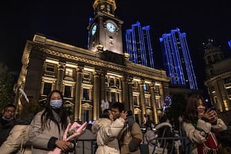 epa08912729 People take selfies as they celebrate the New Year in Wuhan, China, 01 January 2021. Life in Wuhan, a Chinese city of more than 11 million, which nearly a year ago became the epicenter of the coronavirus outbreak is returning to normal.  EPA/ROMAN PILIPEY