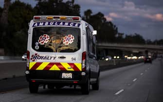 epa08317163 An ambulance drives at high speed on the 10 freeway amid the coronavirus pandemic in Los Angeles, California, USA, 23 March 2020. California Governor Gavin Newsom and Los Angeles Mayor Eric Garcetti have issued a 'Stay at Home' order to curb the spread of coronavirus.  EPA/ETIENNE LAURENT