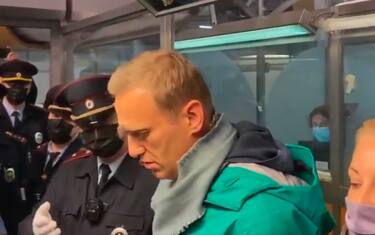 epa08944943 A still image taken from a handout video footage posted by Kira Yarmysh, press-secretary of Alexei Navalny, on Twitter shows Russian opposition leader and anti-corruption activist Alexei Navalny (2-R), during his detention by officers of the Russian Federal Penitentiary Service at the Sheremetyevo airport in Moscow, Russia, 17 January 2021. Alexei Navalny was detained after his arrival to Moscow from Germany.  EPA/KIRA YARMYSH   EDITORIAL USE ONLY/NO SALES