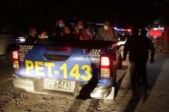 RIO HONDO, GUATEMALA - JANUARY 18: An Honduran migrant family is taken to a Red Cross tent by a police unit on January 18, 2021 in Rio Hondo, Zacapa, Guatemala. The caravan departed from Honduras to walk across Guatemala and Mexico to eventually reach the United States. After clashing with the police yesterday migrants are being held to carry out immigration and heath controls. Central Americans expect to receive asylum and most Hondurans decided to migrate after being hit by recent hurricanes.  (Photo by Getty Images/Getty Images)