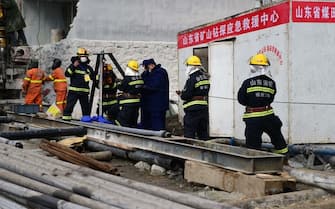 QIXIA, CHINA - JANUARY 20: Rescuers work at the explosion site of a gold mine on January 20, 2021 in Qixia, Shandong Province of China. A life-saving passage into a collapsed gold mine is under construction in Qixia under Yantai City. Rescuers have established contact with some of the 22 miners that got trapped underground following an explosion on Jan. 10. Eleven of the miners were found Sunday through a drilled channel. A total 589 personnel from 16 professional rescue teams and one fire team have been working around the clock. The physical condition of the eight trapped miners have improved after they received nutritious supplies, while one was in a coma and two experiencing mild discomfort. (Photo by Yang Bing/China News Service via Getty Images)