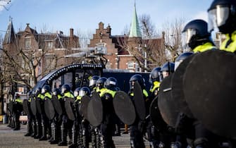 epa08977621 Police officers from the Mobile Unit (ME) are ready to intervene at Museumplein, Amsterdam, Netherlands, 31 January 2021. According to media reports, Museumplein, is once again, classified as a 'security risk area', giving police officers the right to check and search anybody in that area without a cause. The police are extra vigilant about demonstrations and riots on Museumplein, after things got out of hand a week earlier.  EPA/ANP09