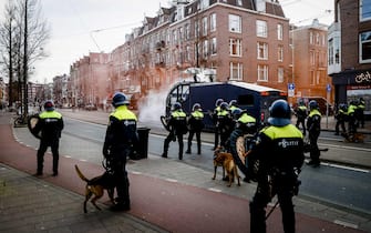 epa08977767 Police takes position against protesters at Museumplein, in Amsterdam, Netherlands, 31 January 2021. Amsterdam Mayor Halsema has once again classified as a 'security risk area' Museumplein, giving police officers the right to check and search anybody in that area without a cause. The police are extra vigilant about demonstrations and riots on Museumplein, after things got out of hand a week earlier.  EPA/ANP