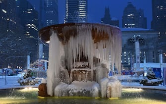 The Josephine Shaw Lowell Memorial Fountain is seen covered in ice during a winter storm on February 1, 2021 in New York City. - A powerful winter storm is set to dump feet of snow along a stretch of the US east coast including New York City on February 1, 2021, after blanketing the nation's capital. The National Weather Service issued storm warnings from Virginia to Maine -- a swathe home to tens of millions of people -- and forecast snowfall of 18 to 24 inches (45-60 centimeters) in southern New York, northeastern New Jersey and parts of southwest Connecticut. (Photo by Angela Weiss / AFP)