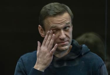 epa08980990 A handout photo made available by Moscow's Citiy Court Press Service shows Russian opposition leader Alexei Navalny (L) reacting in the glass cage during a hearing in the Moscow City Court in Moscow, Russia, 02 February 2021. The Moscow City Court will consider on 02 February 2021 the requirement of the Federal Penitentiary Service to replace Alexei Navalny's suspended sentence with a real one. Opposition leader Alexei Navalny was detained after his arrival to Moscow from Germany on 17 January 2021. A Moscow judge on 18 January ruled that he will remain in custody for 30 days following his airport arrest.  EPA/MOSCOW CITY COURT PRESS SERVICE HANDOUT MANDATORY CREDIT HANDOUT EDITORIAL USE ONLY/NO SALES
