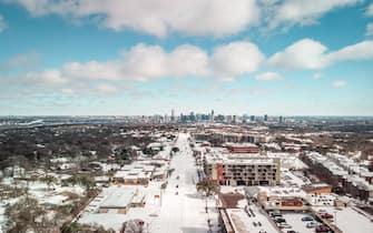 An aerial drone photo of South Lamar Boulevard in Austin, Texas with a layer of snow followed by an arctic blast on Monday Feb. 15, 2021. South Lamar Boulevard is one of the main roads that run into downtown Austin. You can see the cityscape on the horizon. The power is currently out across most of Austin and Texas and residents are advised to stay home. (Photo by Pearcey Proper/Sipa USA)